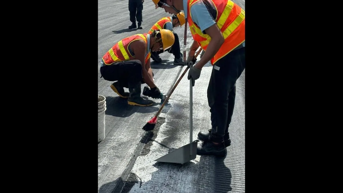 עובדים של שדה התעופה בהונג קונג מפנים חלקי צמיג מהמסלול 